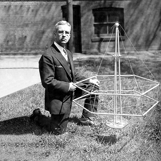 Richard Buckminster Fuller with a model of a geodesic dome.